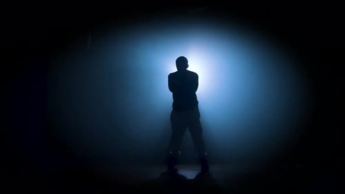 Silhouette of a Man Dancing Break Dance in a Dark Studio Dancer Artist Performing