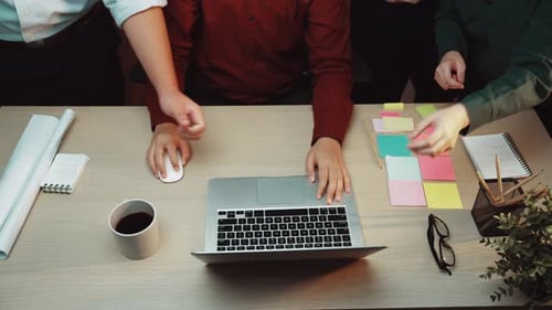 Team Brainstorming Solutions with Puzzle Pieces on Laptop