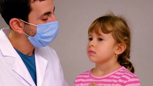 Doctor Examining a Young Girl's Teeth