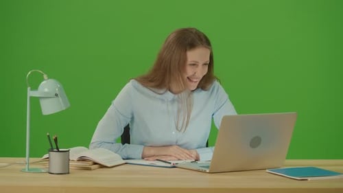 Green Screen. Chroma Key. Young Motivated Woman Freelancer Student Making Video Call and Waving