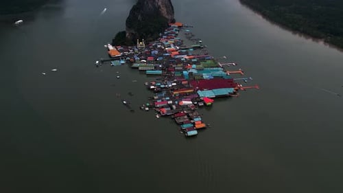 Koh Panyee Floating Fishing Village in Phang Nga, Thailand - Aerial tilt reveal