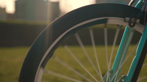 Bike Wheel Rotation at Sunset Girl Cycling in Scenic City Landscape at Sunset Slow Motion