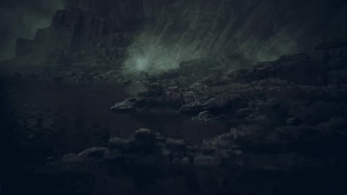 Rocky Coastline Under Dark Clouds at Dusk Near the Waters Edge