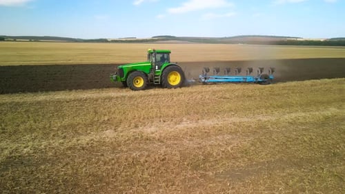 Tractors plowing the field in Ukraine