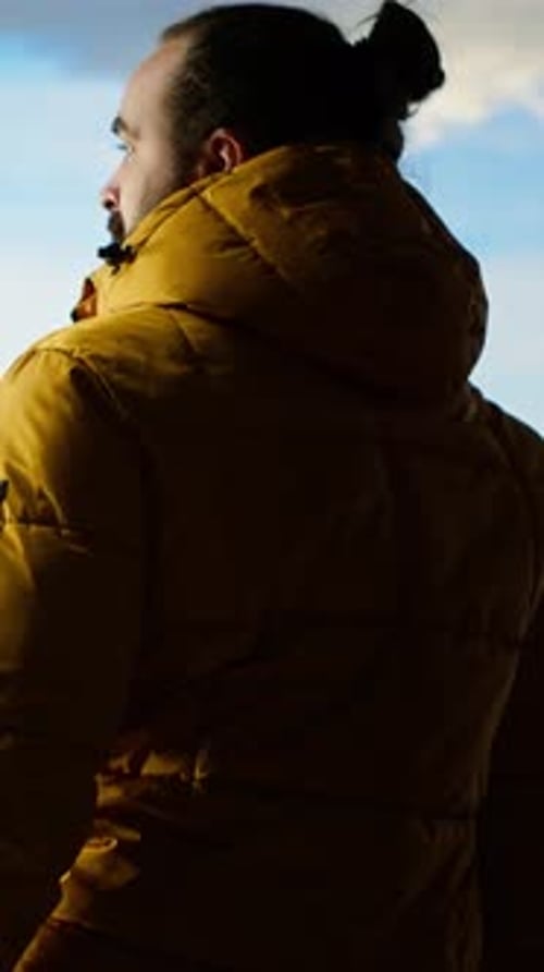 Vertical Video Determined Climber Pauses to Admire the Scenic View with Mountains and Vast Sky