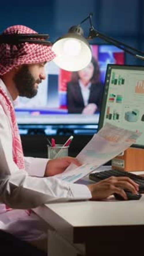 Man in Keffiyeh Working in Brightly Lit Office