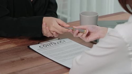 Contract Signing at Desk in Corporate Office