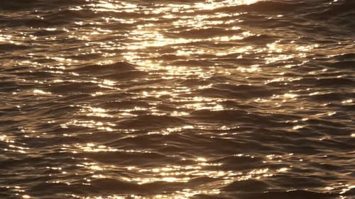 Slow motion sea surface at sunset. Calm soothing waters.