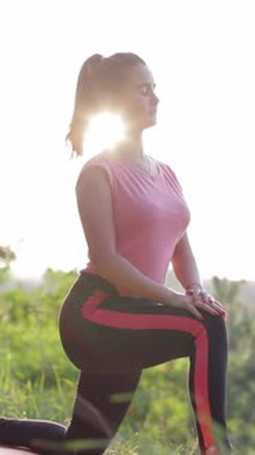 Woman Stretching on Yoga Mat in Sunny Field