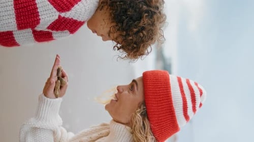 Loving Woman Holding Adorable Child Upward Indoors