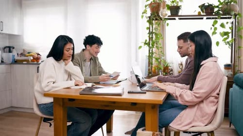 Colleagues Working Together Around a Table with Laptops