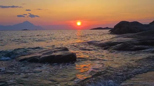 Magical Sunset Above Mediterranean Sea and Beach With Sand and Rocks