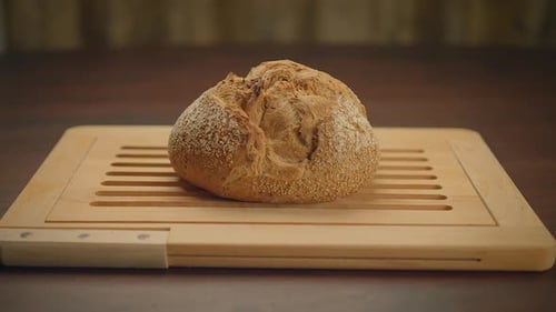 Fresh Baked Bread on Wooden Board Indoors