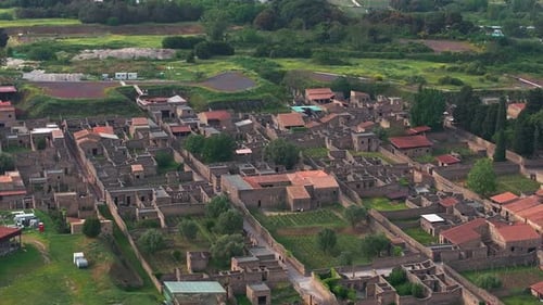 Aerial View of Ancient Pompeii Ruins with Surrounding Greenery