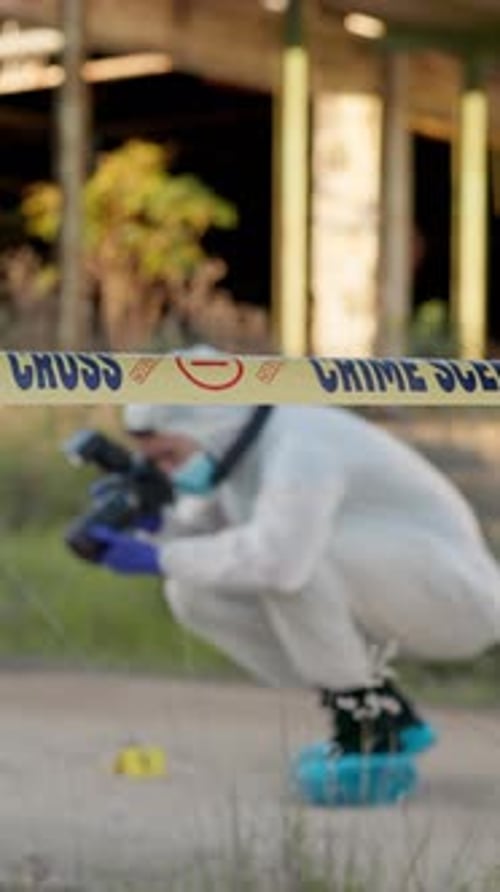 Investigator Inspects Crime Scene Wearing Protective Suit