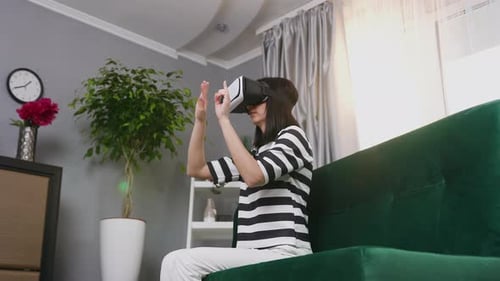 Woman Using Virtual Reality Headset on Couch