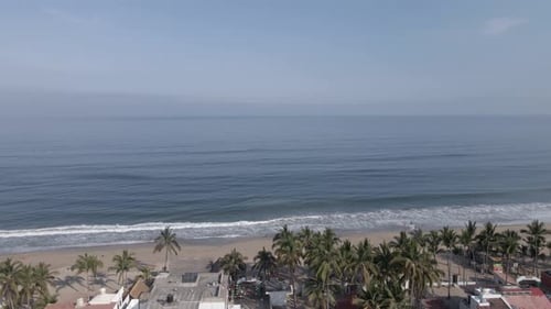 Pan across sandy Pacific Ocean beach horizon at Lo de Marcos in Mexico