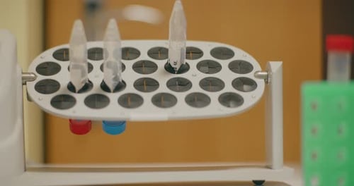 Lab Equipment Rotating Test Tubes with Colored Liquid