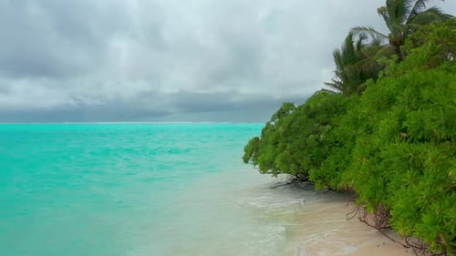 Aerial view on Tropical island in cloudy weather in Maldives.