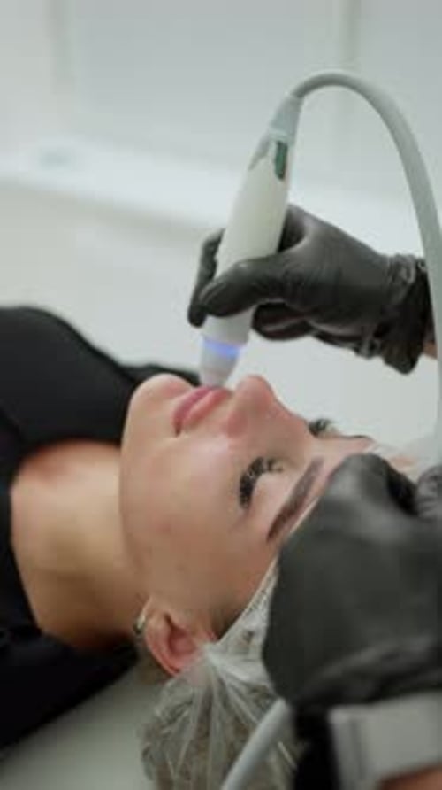Facial Treatment in Clinic with Handheld Device