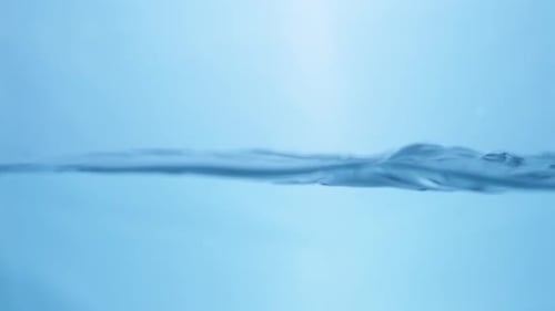 Close-up of a Water Splash in Slow Motion. Crystal Clear Droplets Against White Background.