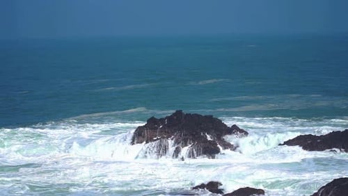 Slow motion of big tidal waves on the rocky beach