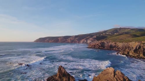 Panoramic View of Lush Green Hills Meeting the Deep Ocean