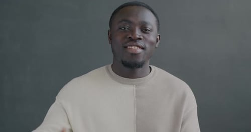 Smiling Young Man Gives Thumbs Up Gesture