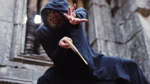 Swordwielding Masked Man At Temple Ruin