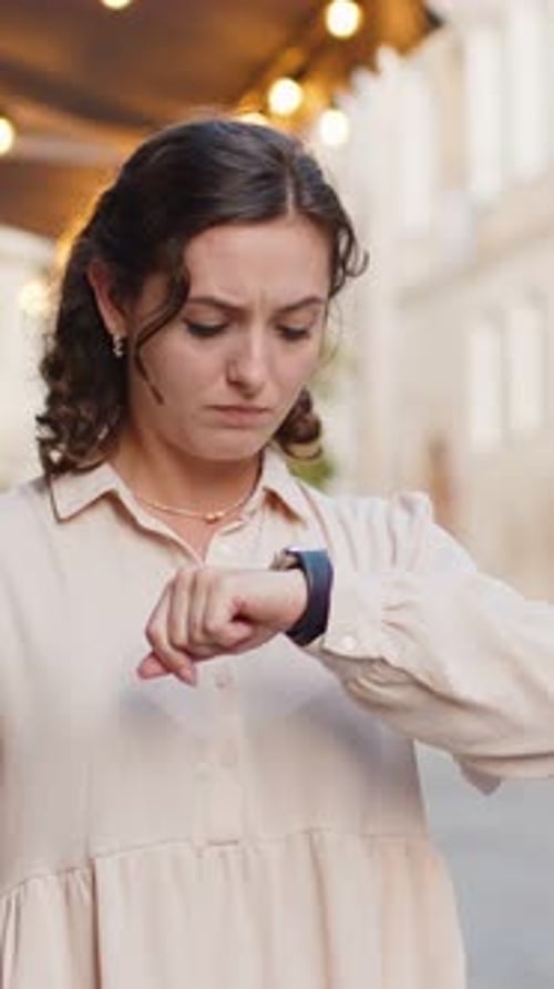 Woman Shocked Looking at Smartwatch Outside