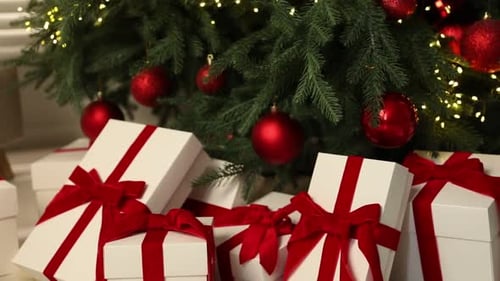 Christmas Presents Under Decorated Tree with Red Ornaments