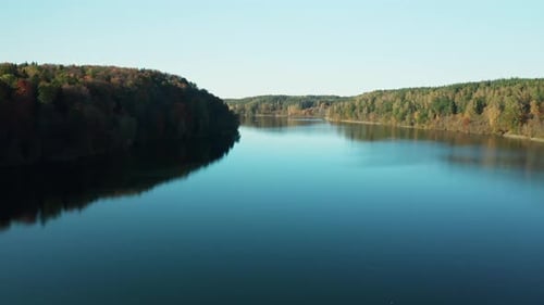 AERIAL: Flying Over Lake near Beautiful Forest in Lithuania