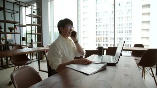 Attractive Mature Businesswoman Working on Laptop in Office or Coworking