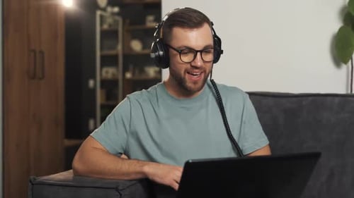 Young Adult Man Video Conferencing at Home