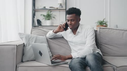 Young Adult Working from Home on Couch