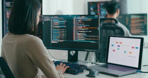 Woman Coding at Computer in Modern Office
