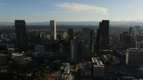 Backwards drone dolley shot of high buildings in the city center of Denver.