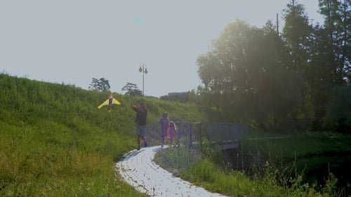 Caucasian Happy Family Spending Time Together Having Fun with Kid in Park Near Lake Flying Kite Real