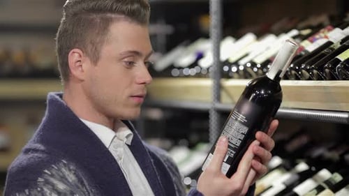 Man Reads Wine Label in Store