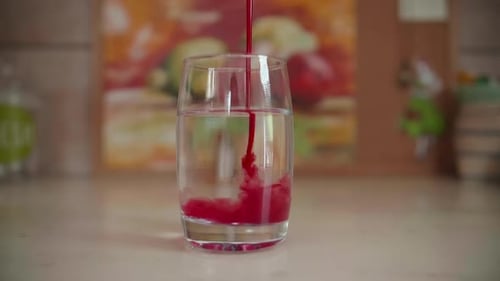 Syrup Poured Into Glass of Water