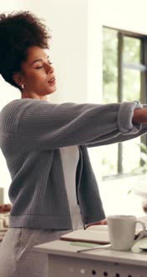 Woman Stretching Arms at Standing Desk