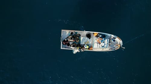 Fishermen in Small Boat Trawling Sardines and Sea Fish in Ocean