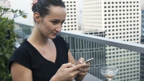 Beautiful Woman Texting On Smartphone In Luxury Bar