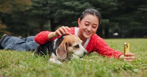 Woman, dog and happy for video call at park, snack and love with phone, excited and relax on lawn