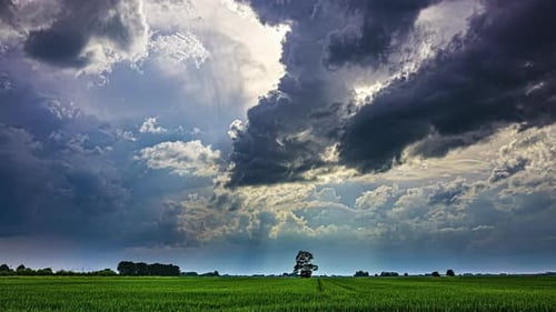 Dramatic Sky Over Green Fields Captured in Timelapse