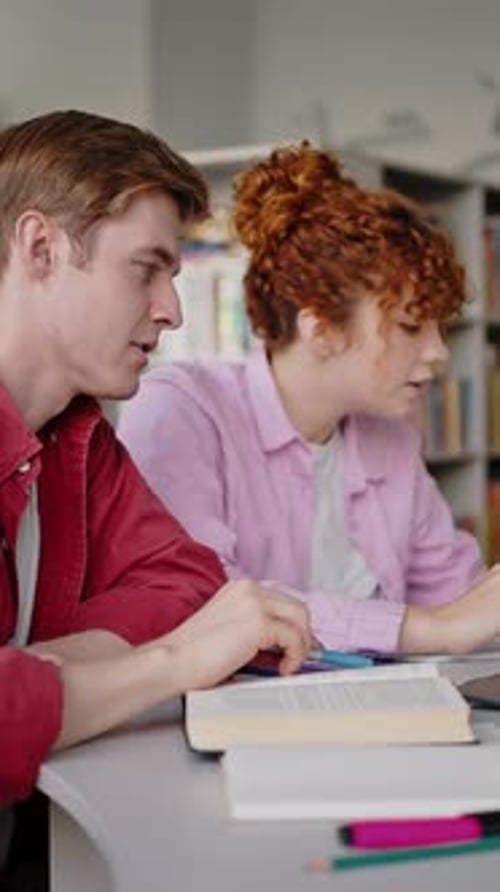 Man and Girl Write Notes and Check Information on Laptop