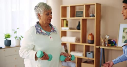 Senior Woman Working Out With Weights and Trainer