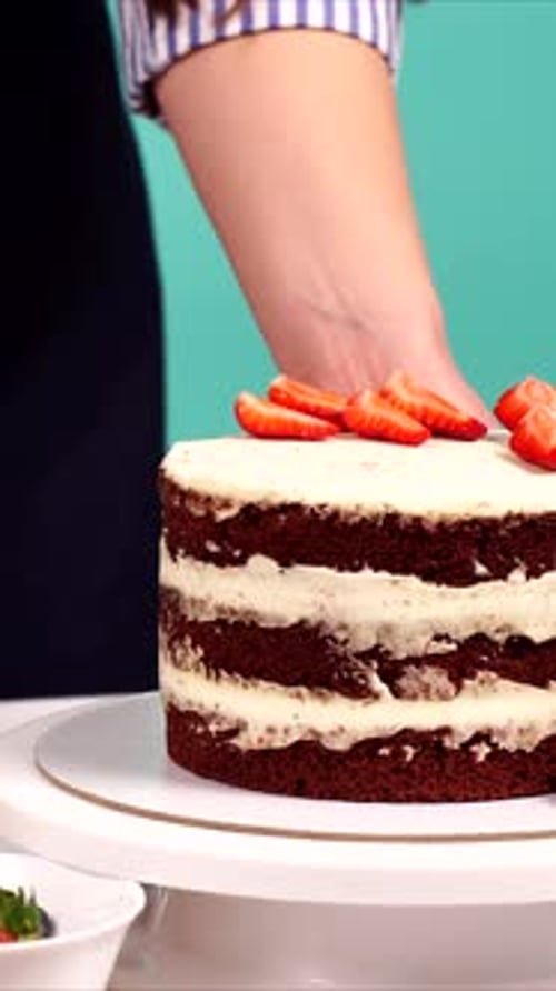 Closeup of a Woman Confectioner's Hand Decorating a Delicious Cake in Studio Vertical Video