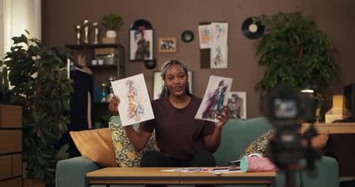 Artist Drawing and Presenting Art to Camera Indoors