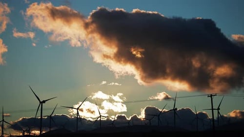 Wind turbines churning out renewable and sustainable clean energy a sunset in the Mojave Desert